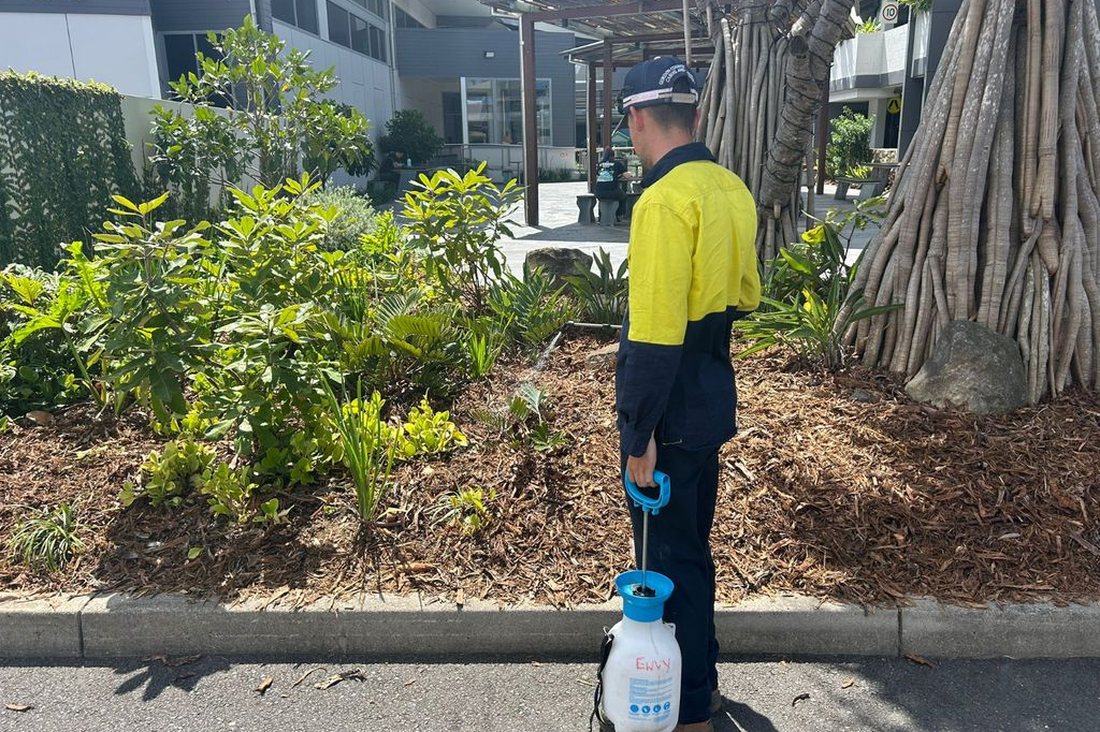 Mount Ommaney Centre — Grolife crew with backpack sprayer at the centre's pergola area